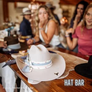 Group of women customizing western style hats